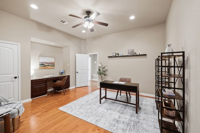 office featuring hardwood / wood-style flooring, built in desk, and ceiling fan