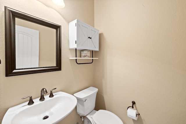 bathroom with toilet and sink