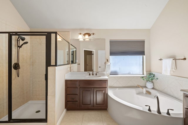 bathroom featuring vanity, tile patterned flooring, shower with separate bathtub, and lofted ceiling