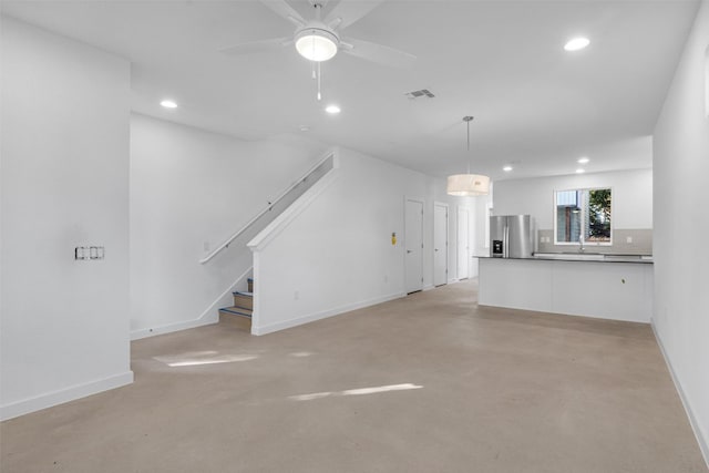 unfurnished living room with ceiling fan