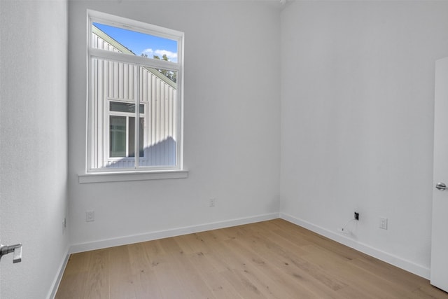 unfurnished room with light wood-type flooring