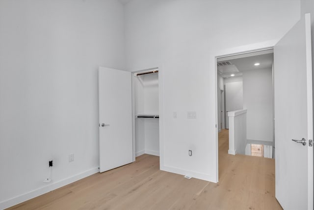 unfurnished bedroom featuring a closet and light hardwood / wood-style floors