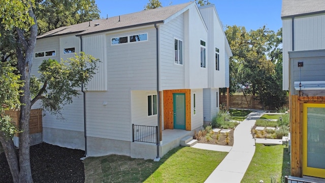 rear view of property with a lawn