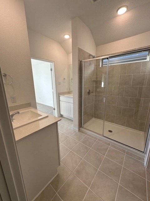 222 Spirit St, Elgin, TX 78621 - full bath with vanity, a stall shower, tile patterned flooring, lofted ceiling, and recessed lighting