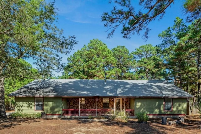 rear view of house featuring a porch