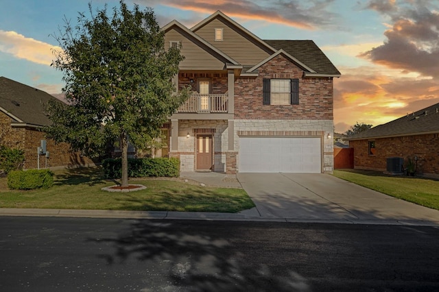 craftsman inspired home featuring a garage, central air condition unit, a lawn, and a balcony