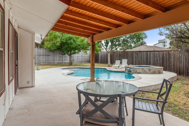 view of pool with a patio and an in ground hot tub