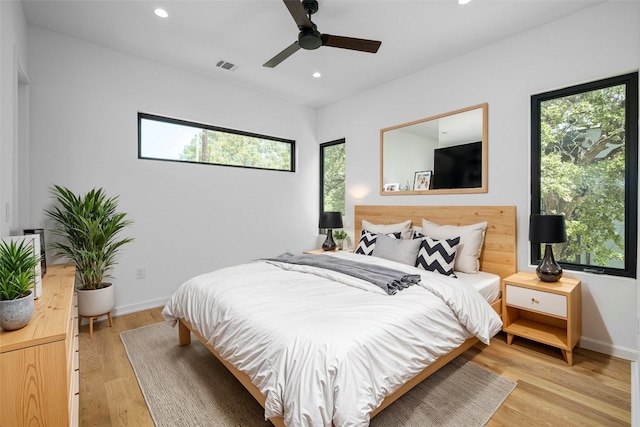 bedroom with ceiling fan and light hardwood / wood-style flooring