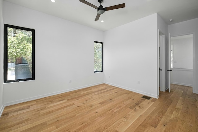 spare room with light hardwood / wood-style floors and ceiling fan