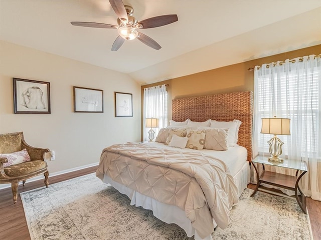 bedroom featuring hardwood / wood-style floors, ceiling fan, and lofted ceiling