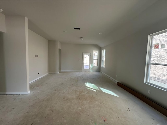 spare room with lofted ceiling