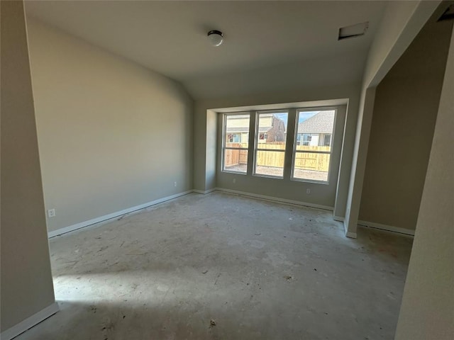 empty room with lofted ceiling