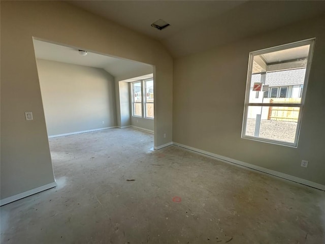 spare room with lofted ceiling