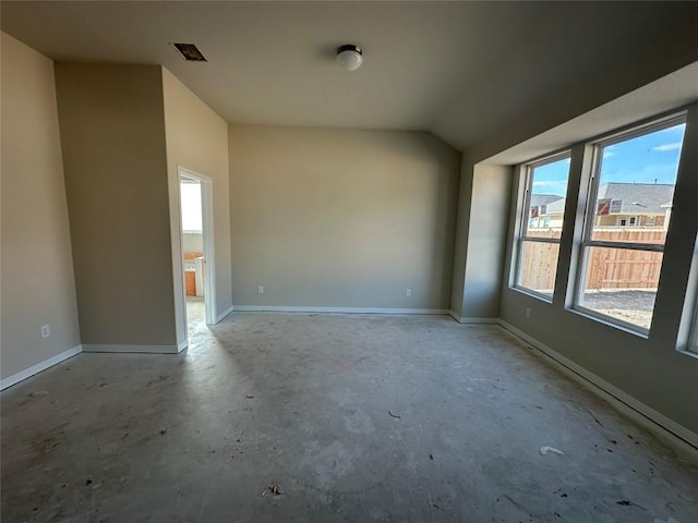 unfurnished room featuring lofted ceiling