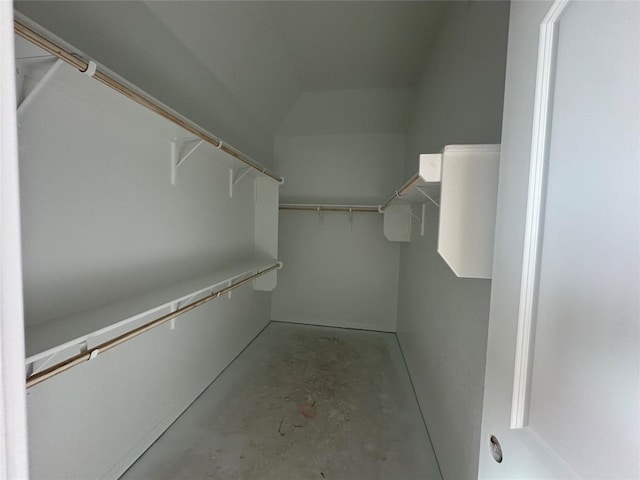 walk in closet featuring lofted ceiling