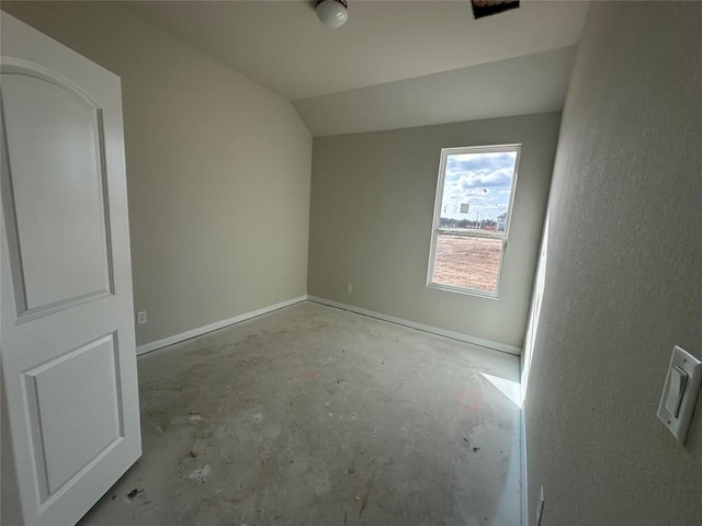 unfurnished room featuring vaulted ceiling