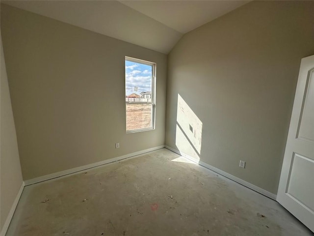 empty room featuring vaulted ceiling