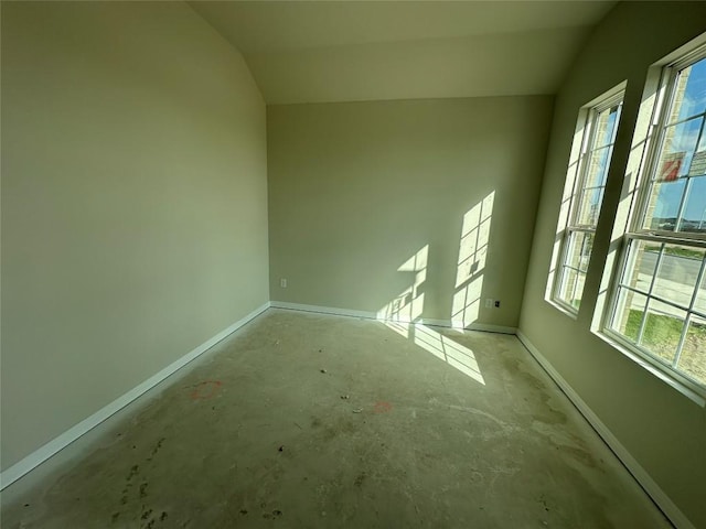 empty room featuring lofted ceiling