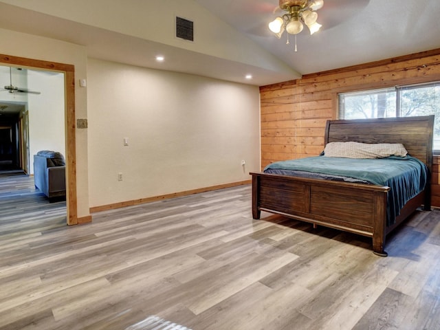 325 Simpson Ave, Cedar Creek, TX 78612 - bedroom featuring vaulted ceiling, light wood finished floors, baseboards, wooden walls, and ceiling fan