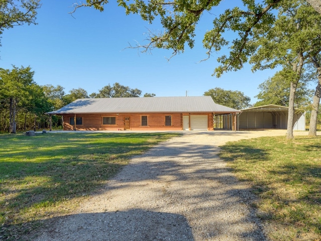 325 Simpson Ave, Cedar Creek, TX 78612 - log home with dirt driveway, a front lawn, a detached carport, metal roof, and an attached garage