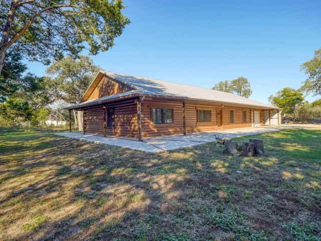 back of property featuring a yard and a patio