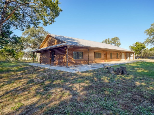 325 Simpson Ave, Cedar Creek, TX 78612 - rear view of house featuring a patio, a lawn, and metal roof