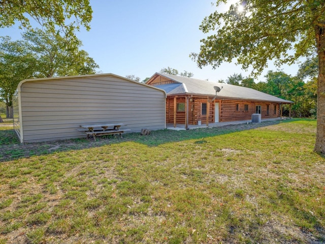 rear view of property with a yard