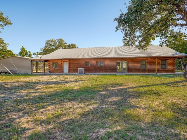 325 Simpson Ave, Cedar Creek, TX 78612 - back of property with log siding, cooling unit, a lawn, and french doors