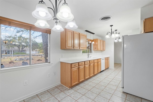 kitchen with a notable chandelier, light tile patterned floors, pendant lighting, sink, and white appliances