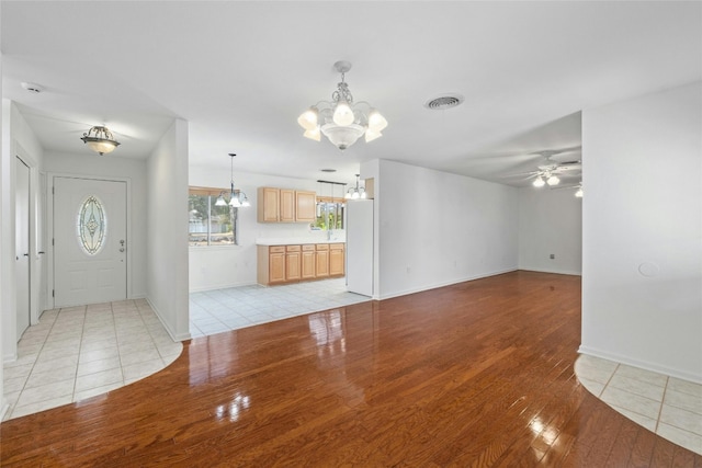 unfurnished living room with ceiling fan and light hardwood / wood-style floors