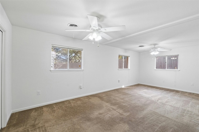 carpeted spare room featuring ceiling fan