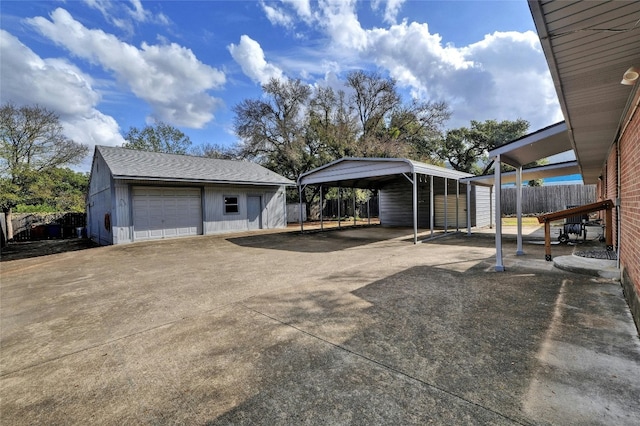 exterior space with an outbuilding, a garage, and a carport