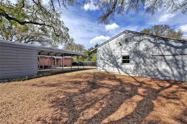 view of side of property with a carport