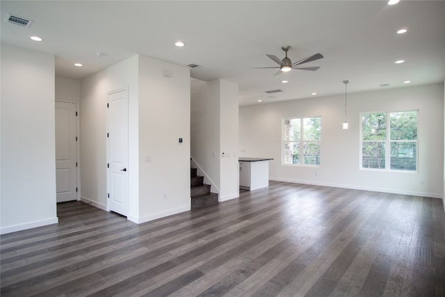 unfurnished living room with dark hardwood / wood-style floors and ceiling fan