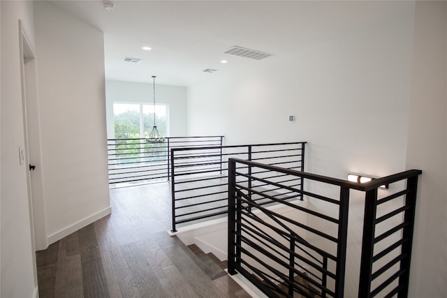 hall featuring a chandelier and dark hardwood / wood-style flooring