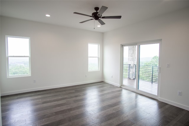 unfurnished room featuring dark wood-type flooring, a healthy amount of sunlight, and ceiling fan