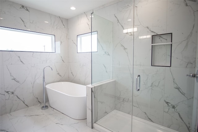 bathroom featuring tile walls and plus walk in shower