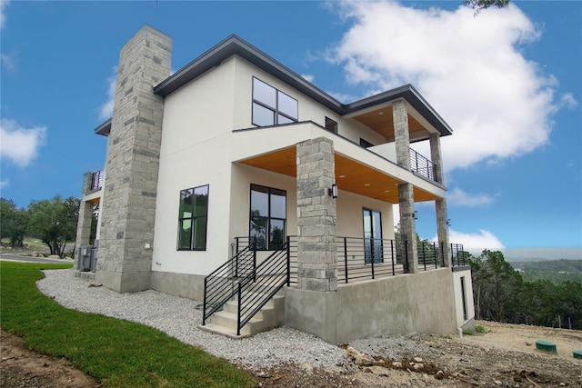 back of house featuring a balcony