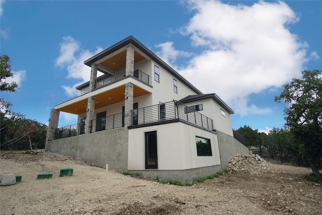 back of property with a balcony