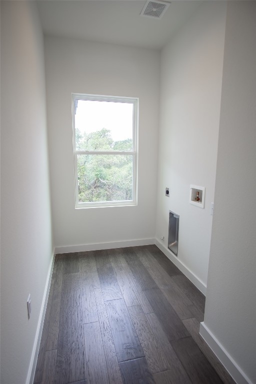 laundry area with electric dryer hookup, dark hardwood / wood-style floors, and washer hookup