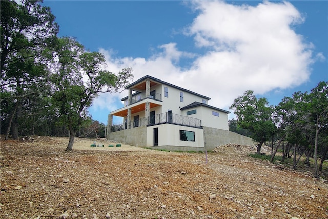 view of side of property with a balcony