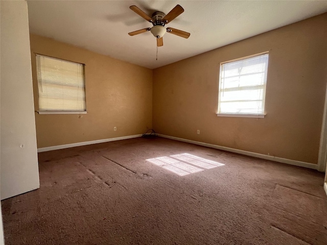 carpeted spare room featuring ceiling fan