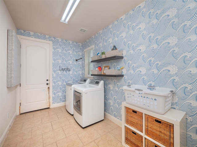 laundry area featuring light tile patterned floors and independent washer and dryer