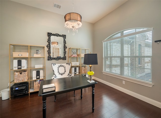 office space with lofted ceiling, a notable chandelier, a healthy amount of sunlight, and dark hardwood / wood-style floors