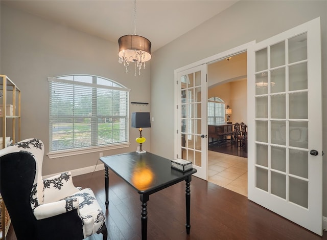 office space with hardwood / wood-style floors, a chandelier, and french doors