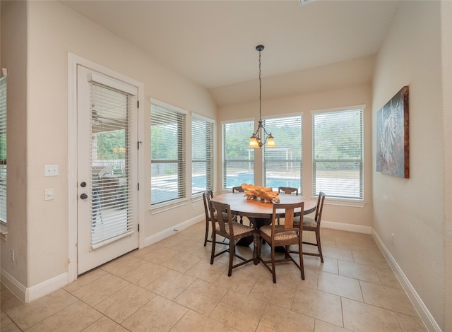 tiled dining space featuring a chandelier