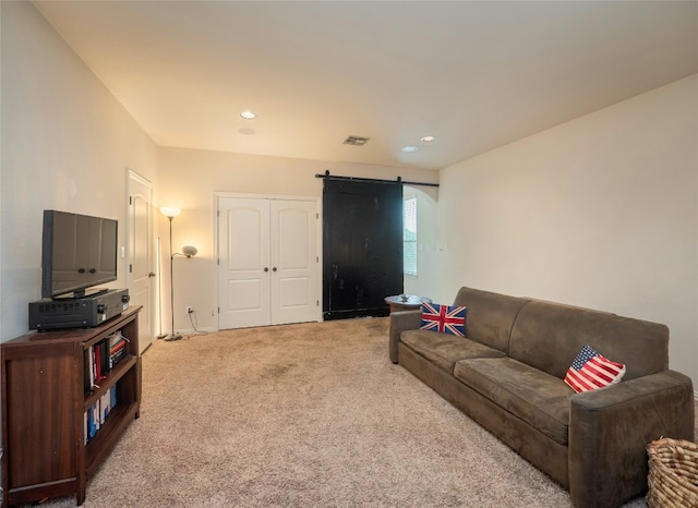 carpeted living room featuring a barn door