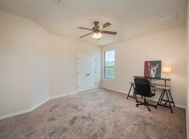 unfurnished office featuring ceiling fan and carpet