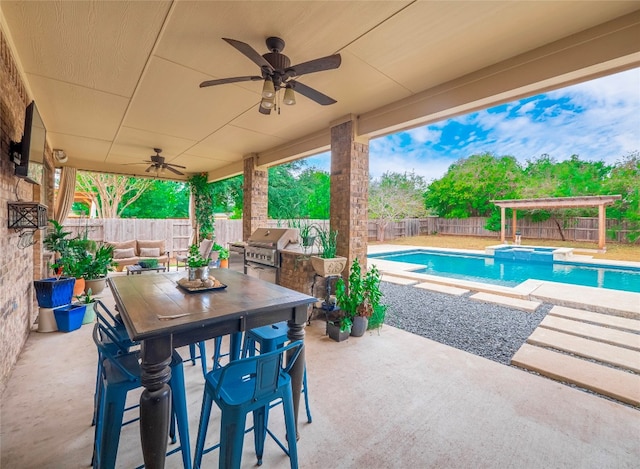 exterior space with a fenced in pool, exterior kitchen, a grill, and ceiling fan