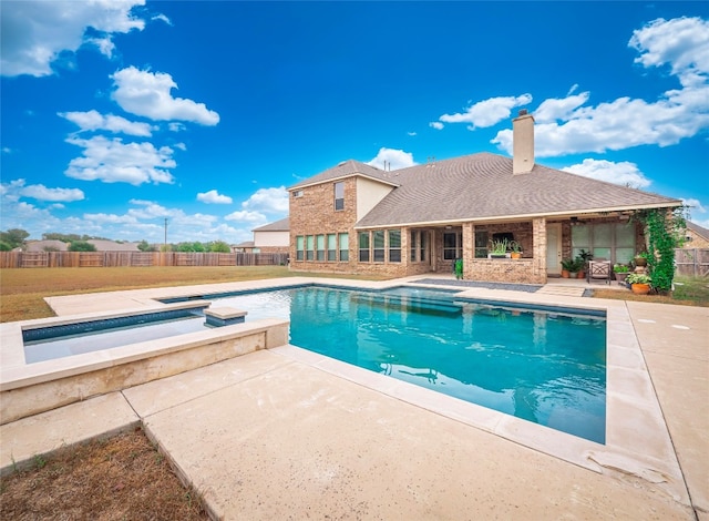 view of swimming pool featuring an in ground hot tub and a patio area